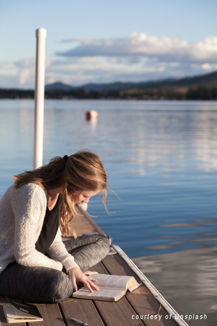 reading a book by the water